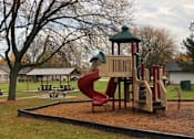 Thumbnail 17 of 27 - a playground with a slide in a park