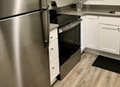 Thumbnail 26 of 27 - a kitchen with stainless steel appliances and white cabinets