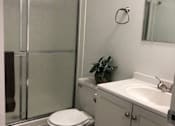 Thumbnail 25 of 27 - a bathroom with a shower and a toilet and a sink