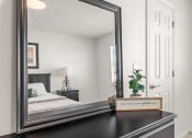 Thumbnail 5 of 15 - a photo of a mirror in a bedroom
