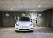 Thumbnail 26 of 32 - a white tesla car parked at a charging station