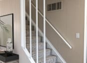 Thumbnail 20 of 27 - a set of stairs with white railings and gray carpet
