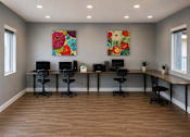 Thumbnail 19 of 23 - A room with a long table and chairs and two paintings on the wall.