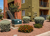 Thumbnail 5 of 23 - A red brick house with a green box in front.