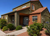 Thumbnail 3 of 23 - A house with a red tile roof and a brown door.