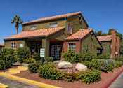 Thumbnail 14 of 23 - A building with a red tile roof and a sign in front of it.
