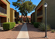 Thumbnail 4 of 23 - A street light stands on a sidewalk in front of a building.