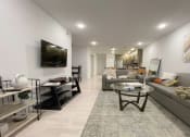 Thumbnail 11 of 11 - a living room with couches and a glass table
