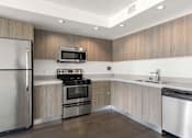 Thumbnail 42 of 49 - A modern kitchen with stainless steel appliances and wooden cabinets. at The View, California