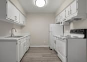 Thumbnail 8 of 24 - a white kitchen with white appliances and white cabinets