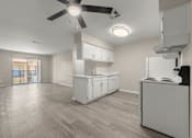 Thumbnail 10 of 24 - an empty kitchen and living room with a ceiling fan