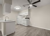 Thumbnail 9 of 24 - a kitchen with white appliances and a ceiling fan