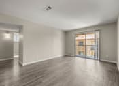 Thumbnail 14 of 24 - the living room of a new home with a large window and wood flooring