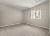 Thumbnail 18 of 24 - an empty room with carpet and a window
