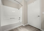 Thumbnail 22 of 24 - a white bathroom with a tub and a shower in it