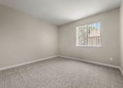 Thumbnail 20 of 24 - an empty living room with a window and carpet