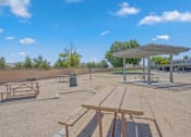 Thumbnail 4 of 18 - a picnic area with benches and picnic tables