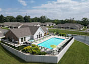 Thumbnail 5 of 20 - A large house with a pool in the backyard.