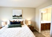 Thumbnail 3 of 15 - A bedroom with a large bed and a painting on the wall.