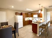 Thumbnail 8 of 15 - A kitchen with a white refrigerator and wooden cabinets.