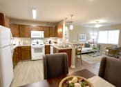Thumbnail 7 of 15 - A kitchen with brown cabinets and a white refrigerator.