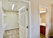 Thumbnail 4 of 15 - A white door is open to a bathroom.