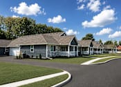 Thumbnail 14 of 42 - A row of houses with a clear blue sky above them.