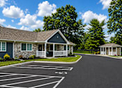 Thumbnail 8 of 42 - An apartment with a driveway in front of it.
