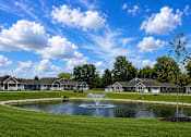 Thumbnail 13 of 42 - A pond in front of apartment buildings.