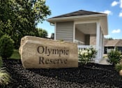 Thumbnail 1 of 42 - A large stone with the words Olympic Reserve is in front of a mailbox area.