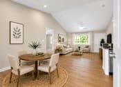 Thumbnail 19 of 42 - A dining room with a round table and chairs.