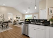 Thumbnail 17 of 42 - A kitchen and dining area open to a living room.