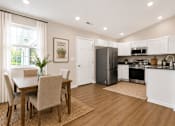 Thumbnail 28 of 42 - A kitchen with a dining table and chairs.