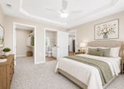 Thumbnail 31 of 42 - A bedroom with a large bed and a ceiling fan.