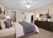 Thumbnail 40 of 42 - A bedroom with a bed, dresser, and ceiling fan.