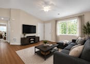 Thumbnail 37 of 42 - A living room with couch , coffee table, tv and entertainment stand.
