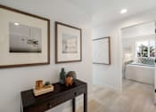 Thumbnail 10 of 39 - a bedroom with a dresser and two framed pictures on the wall