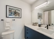 Thumbnail 36 of 39 - a bathroom with a toilet sink and mirror