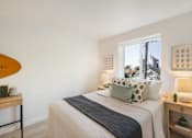 Thumbnail 14 of 39 - a bedroom with a bed and two night stands with lamps