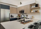 Thumbnail 1 of 39 - a kitchen with a white counter top and a stainless steel refrigerator