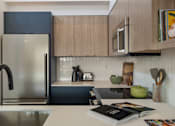 Thumbnail 5 of 39 - a kitchen with wooden cabinets and stainless steel appliances