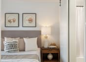 Thumbnail 28 of 39 - a bedroom with a bed and two pictures on the wall