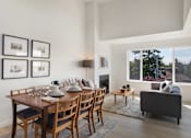 Thumbnail 8 of 39 - an open concept living room and dining room with a wooden table and chairs and a large window