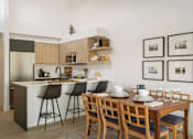 Thumbnail 32 of 39 - a kitchen and dining area in a 555 waverly unit