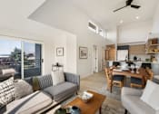 Thumbnail 9 of 39 - a living room with a couch a table and a chair