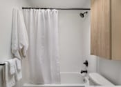 Thumbnail 38 of 39 - a bathroom with a bathtub and a toilet