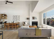 Thumbnail 19 of 39 - a view of the living room and dining area of a house with a large window