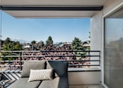 Thumbnail 13 of 39 - a balcony with a couch and a sliding glass door