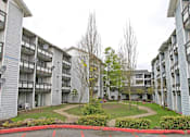 Thumbnail 12 of 15 - Apartment complex with a red border around the grassy area.