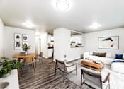 Thumbnail 1 of 15 - A modern living room with a white couch and a wooden coffee table.